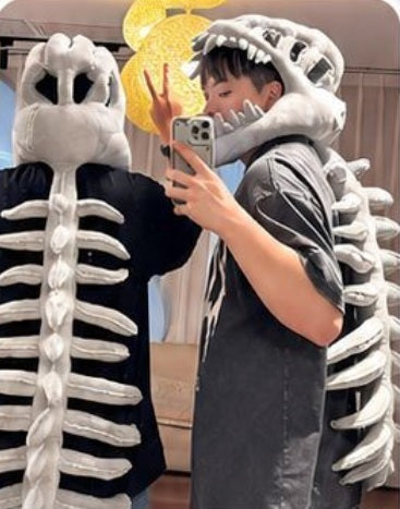 Two people wearing gray dinosaur skeleton hoods taking a mirror selfie